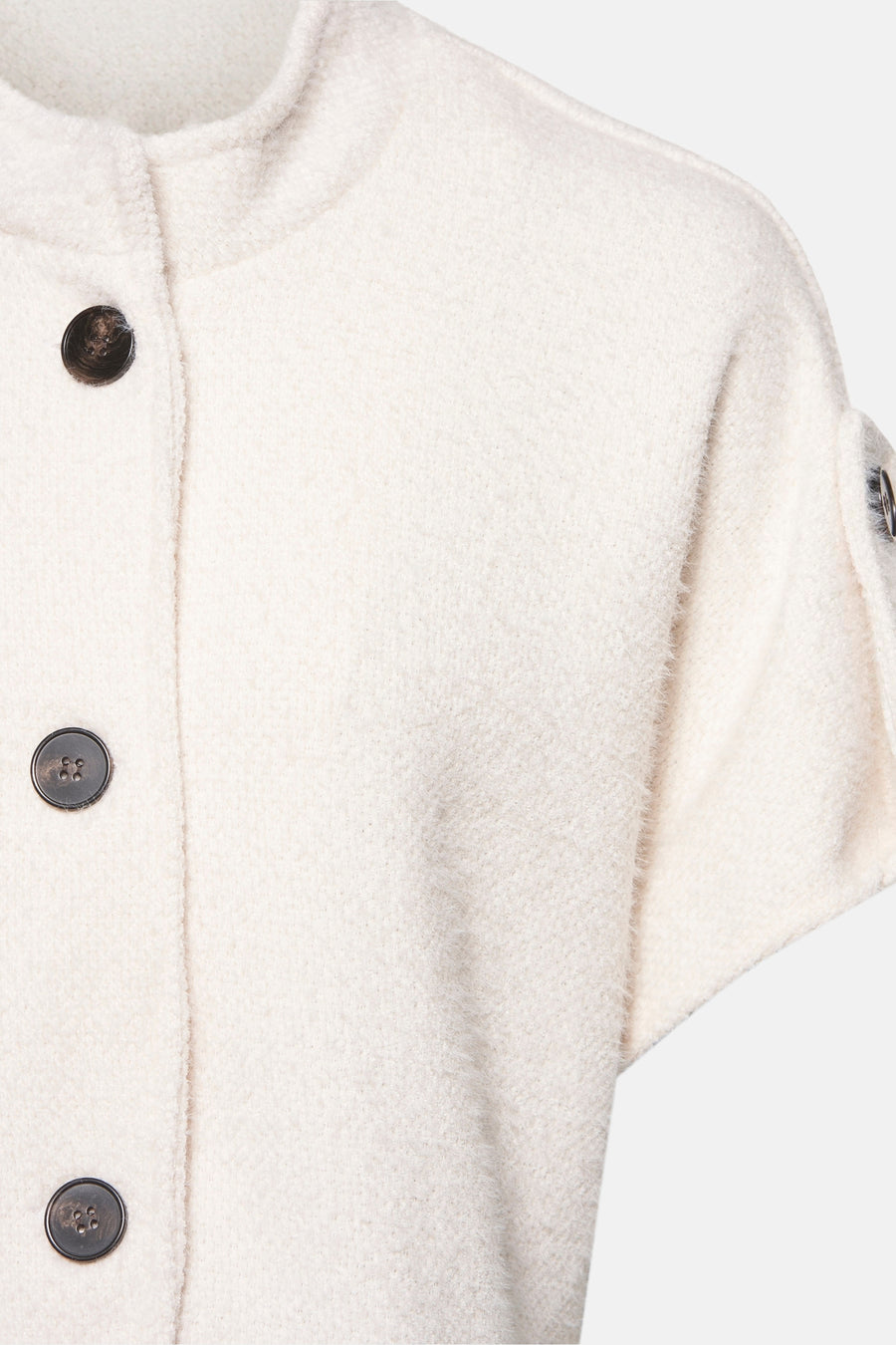 Cardigan écru de Terra di Siena, avec fermeture à boutons et manches courtes, dans une texture bouclée douce.