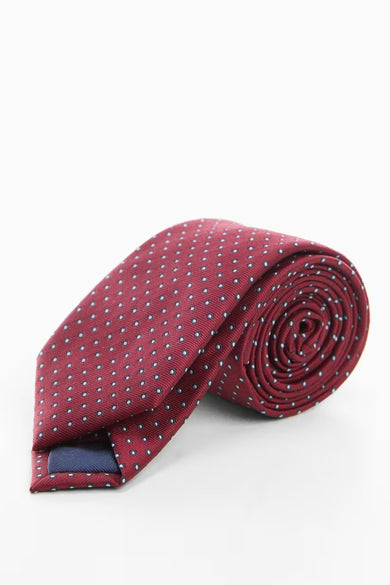 Doudoune MANGO en rouge, avec un motif à points subtil et présentée roulée.