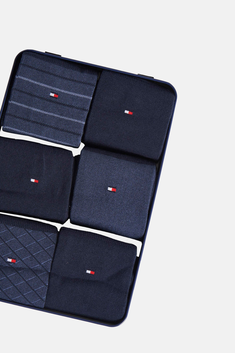 Chaussettes bleues de TOMMY JEANS, en un ensemble avec différentes textures et motifs tissés, présentées dans une boîte-cadeau bleu marine.