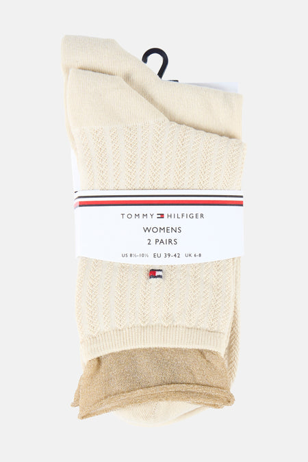 Chaussettes beiges pour femmes de TOMMY JEANS, avec un motif ajouré et des détails scintillants dorés sur le bord.