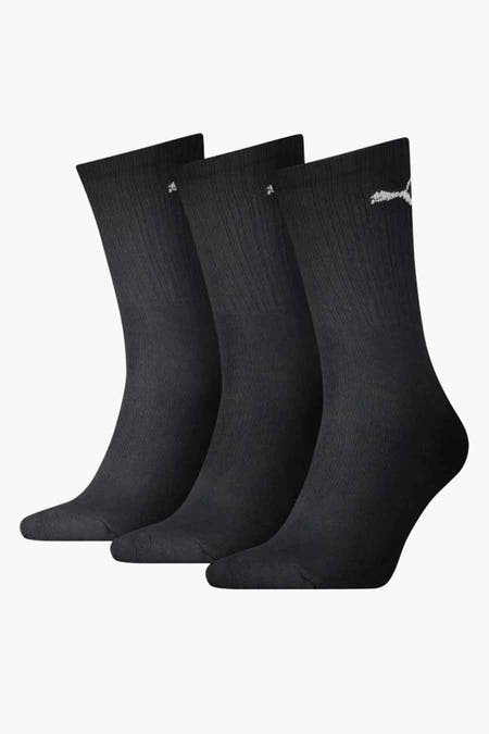 Chaussettes noires de PUMA, avec un logo subtil sur le côté, texture côtelée.