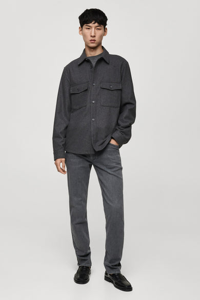 Chemise grise à manches longues de MANGO, avec poches et jeans gris et chaussures noires.