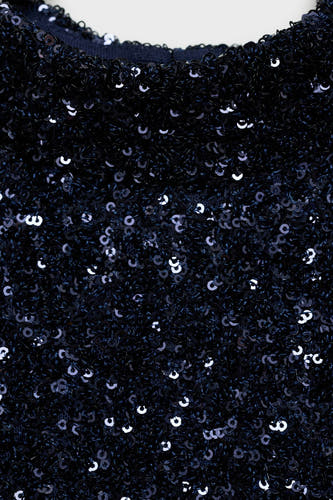 Tunique bleue à manches courtes de MANGO, recouverte de paillettes scintillantes pour une texture festive.