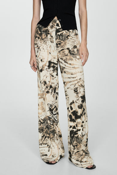 Beige broek van MANGO met een opvallende dierenprint en wijde pijpen, gecombineerd met een zwart topje.