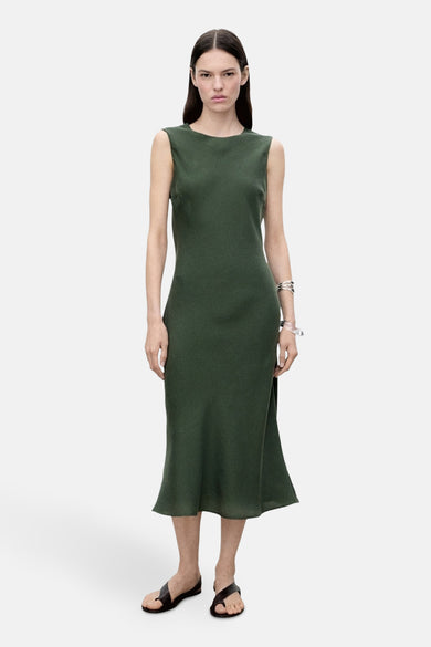 Robe sans manches verte de MANGO, avec une longueur jusqu'aux genoux et portée avec des sandales.