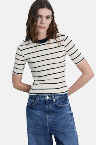 Wit T-shirt met korte mouwen van MANGO, met marineblauwe horizontale strepen, gecombineerd met jeans.
