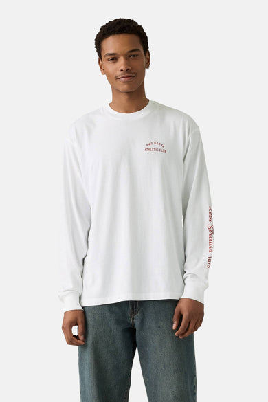 Wit T-shirt met lange mouwen van Levi's®, met rode "Two Horse Athletic Club" tekstprint en blauwe jeans.