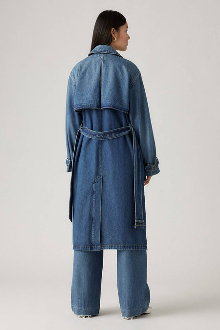 Donkerblauwe denim trenchcoat van Levi's®, achterzijde met riem en zakken, model draagt bijpassende jeansbroek