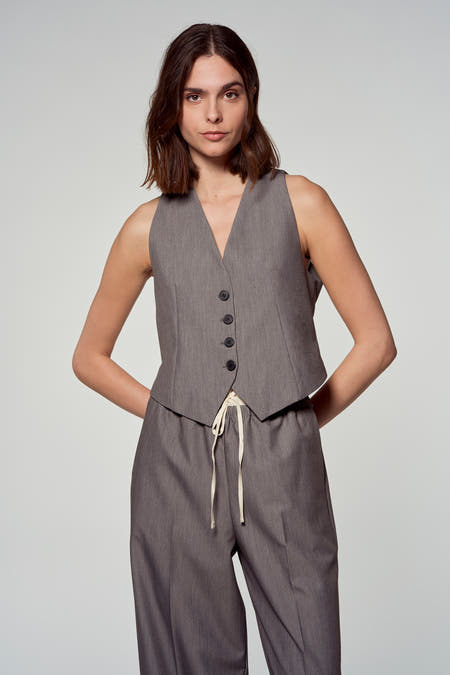 Grijze blazer van Astrid Black Label, gedragen met een bijpassende broek met trekkoord op een model.
