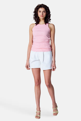 Witte short van Astrid Black Label, gedragen met een roze top en sandalen met bandjes.