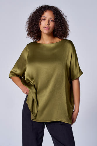 Groene blouse met korte mouwen van Astrid Black Label, met een glanzende textuur en gedragen met een zwarte broek.
