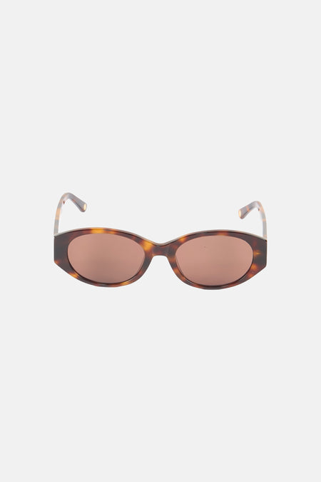Oranje bril van Astrid Black Label, met een gevlekt montuur en bruine glazen.