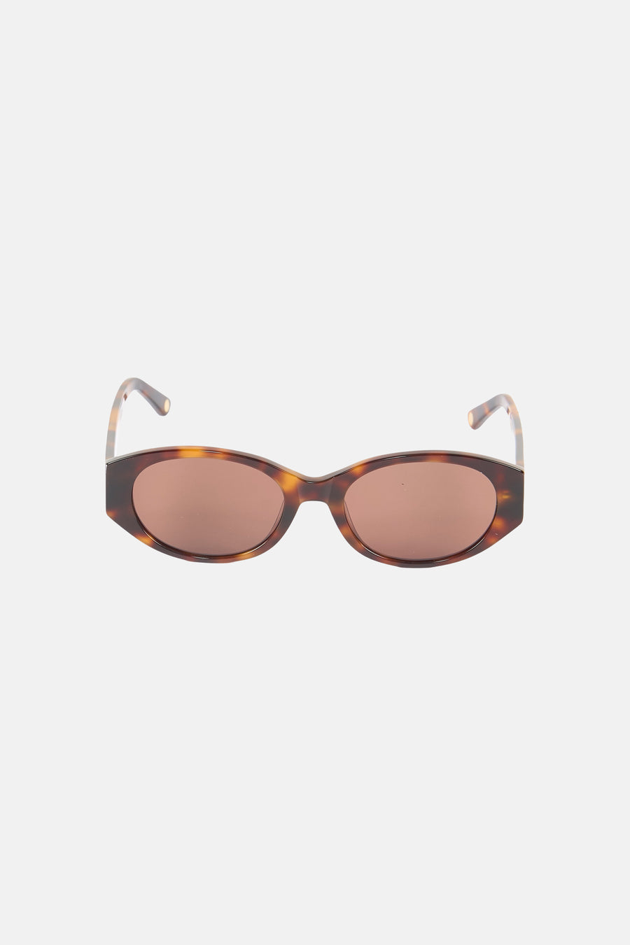 Oranje bril van Astrid Black Label, met een gevlekt montuur en bruine glazen.