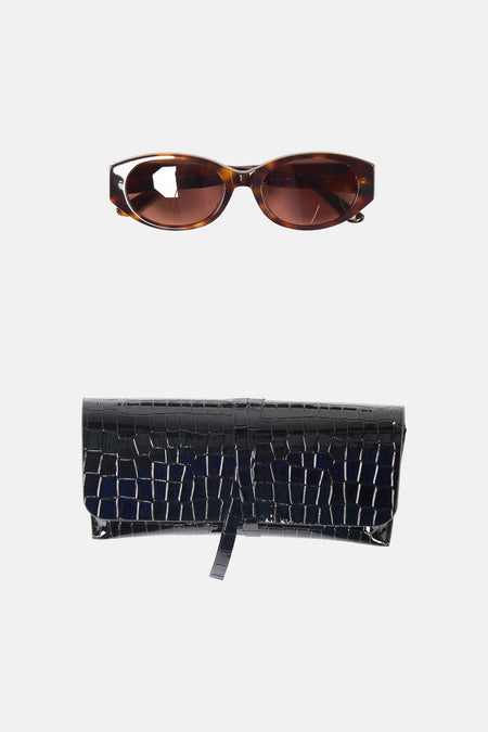 Bruine bril van Astrid Black Label met een zonnebril-montuur.