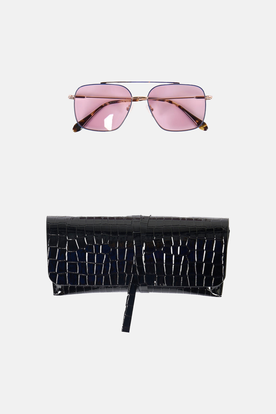 Lunettes de soleil violettes Astrid Black Label, avec monture dorée et étui noir à imprimé croco.