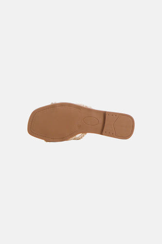 Pantoufles de couleur écru d'Astrid Black Label, avec semelle plate et bride tressée sur le cou-de-pied.