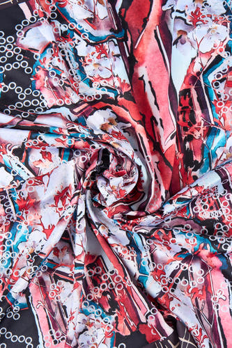 Multikleurige zomersjaal van Astrid Black Label, met gedraaide textuur en abstract bloemmotief in rood, wit en blauw.
