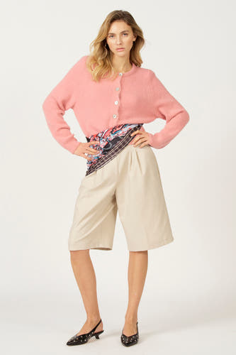 Roze gilet van Astrid Black Label, met knoopsluiting, gecombineerd met een broek en zwarte pumps.