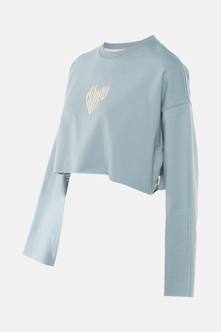 Turquoise sweater van KAOTIKO, met lange mouwen, cropped model en een geborduurd detail.

