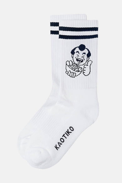 Witte sokken van KAOTIKO met donkerblauwe strepen aan de bovenkant en een cartoonafbeelding.
