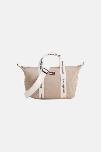 Beige schoudertas van TOMMY JEANS, met witte banden voorzien van logo en een verstelbare schouderriem.
