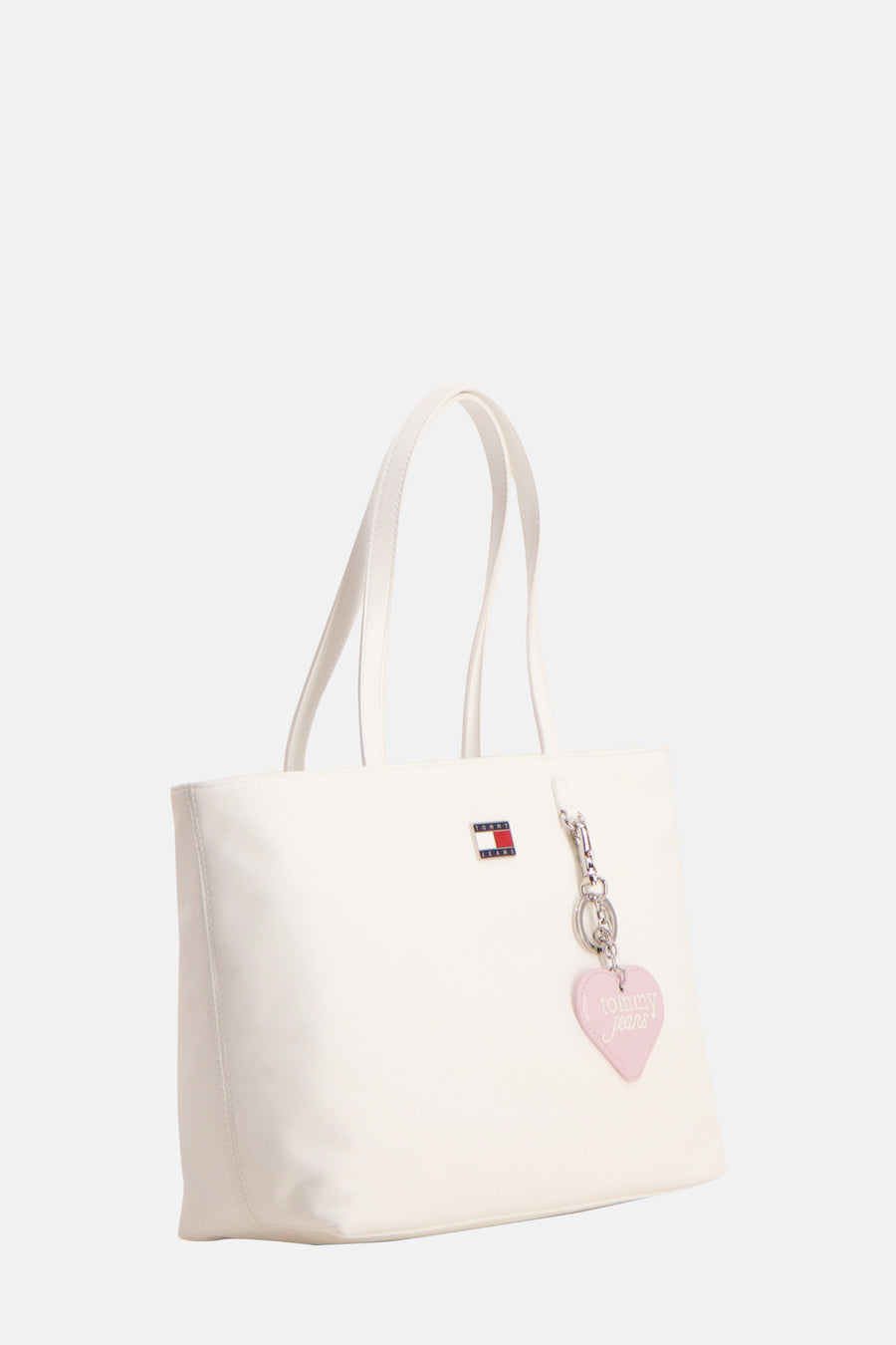 Witte schoudertas van TOMMY JEANS met twee hengsels en een roze hartvormige hanger.