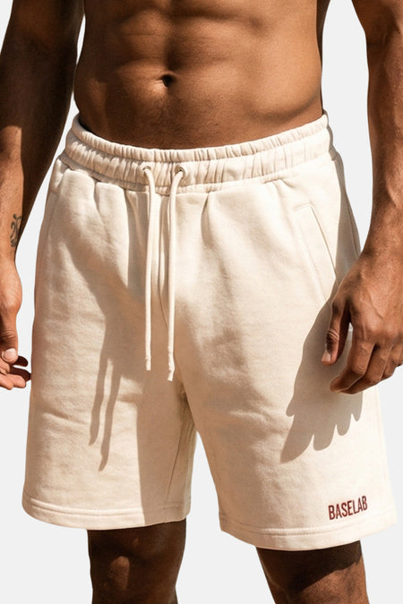 Witte katoenen shorts van BASELAB met elastische tailleband en trekkoord, voorzien van zakken en logo op de pijp, in front view.