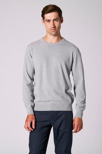 Sweat-shirt gris avec col rond de Bruce & Butler, porté avec un pantalon bleu marine.