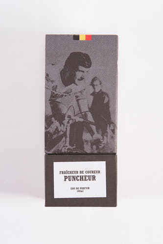 Zwarte parfum van Cyclo Club Marcel, met een stippenpatroon en een illustratie van een vrouw en een man op de doos.
