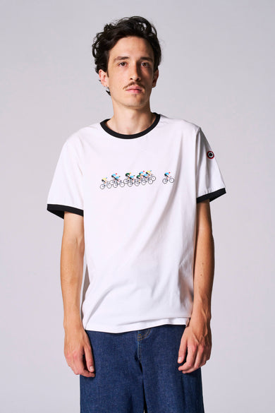 Wit T-shirt met korte mouwen van Cyclo Club Marcel, met een print van fietsers en zwarte bies rond de hals en mouwen, gedragen met een donkere spijkerbroek.

