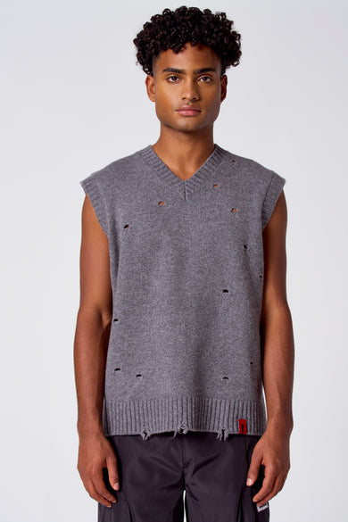 Gilet gris de COELY, avec col V et trous décoratifs sur toute la surface.