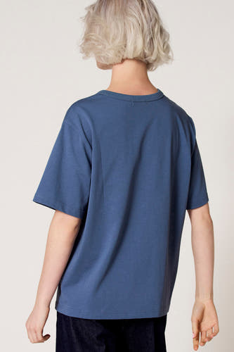 Blauw T-shirt met korte mouwen van Clouds of Fashion, gezien van achteren, gecombineerd met een donkere broek.

