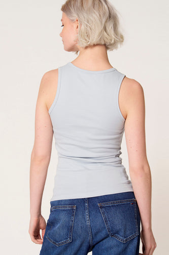Blauwe singlet van Clouds of Fashion, met een effen ontwerp, gedragen met een donkerblauwe jeans.
