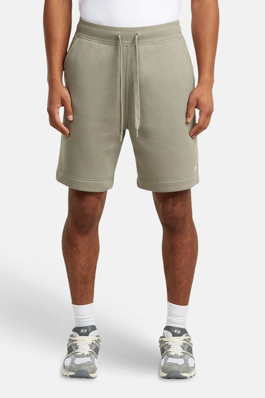 Short de survêtement gris de G-Star RAW, vue arrière avec poche arrière plaquée et étiquette de marque, porté avec des chaussettes blanches et des baskets.