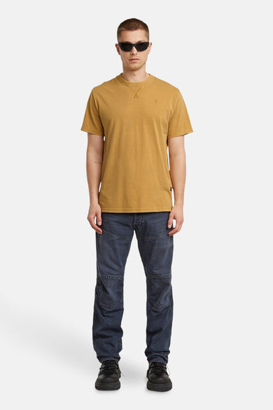 Geel T-shirt met korte mouwen van G-Star RAW, gedragen met een donkere jeans en zwarte schoenen.