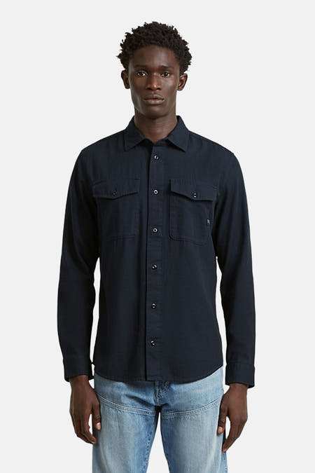 Blauw overhemd met lange mouwen van G-Star RAW, met twee borstzakken en een volledige knoopsluiting, gecombineerd met een spijkerbroek.