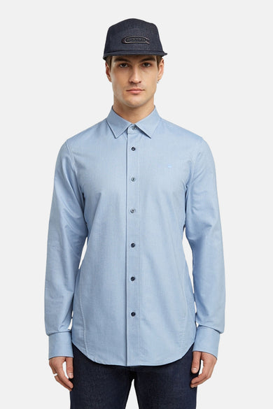 Chemise bleue à manches longues de G-Star RAW, portée avec un chapeau bleu marine.