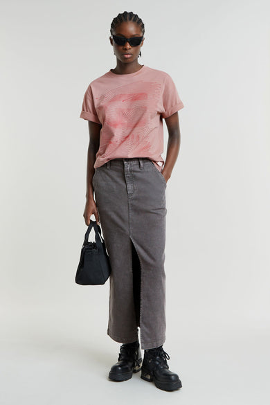 Lange rok van middengrijs denim van G-Star RAW met hoge split aan de voorkant, gestyled met een roze T-shirt en zwarte boots.
