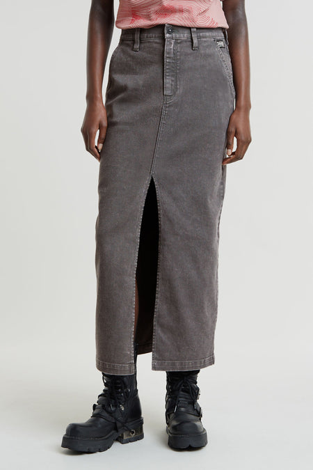 Donkergrijze denim lange rok van G-Star RAW, met hoge split aan de voorkant, gedragen met roze top en zwarte laarzen.