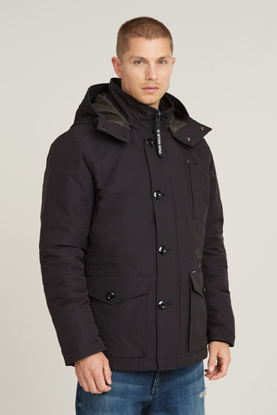 Lange zwarte jas van G-Star RAW, met knopen, zakken en een capuchon.
