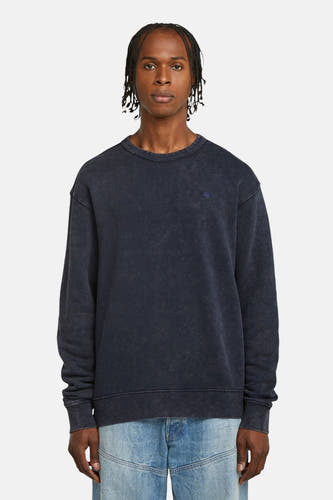 Blauwe sweater van G-Star RAW, met lange mouwen en gedragen op een jeans.