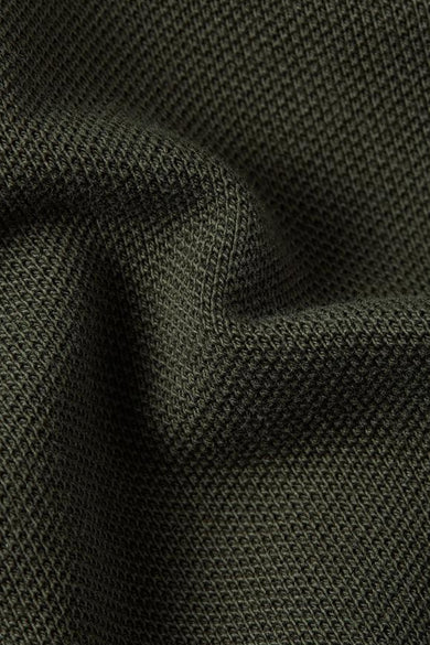 Groene polo met lange mouwen van G-Star RAW, met een wafelstructuur en plooien in de stof.
