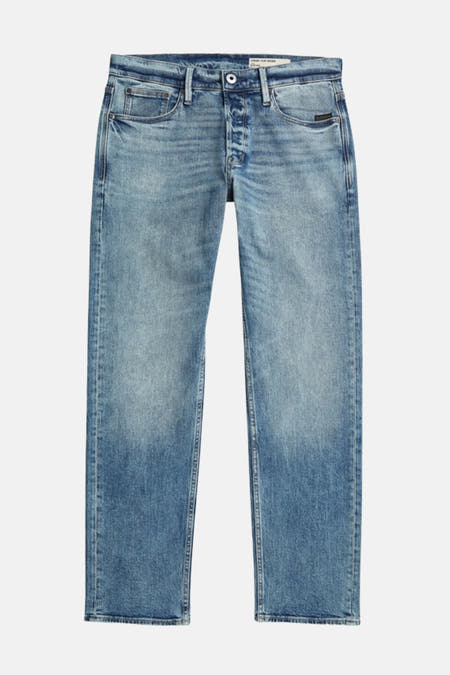 Jeans fuselés en denim bleu de G-Star RAW, avec un délavage stone wash et une fermeture à boutons.