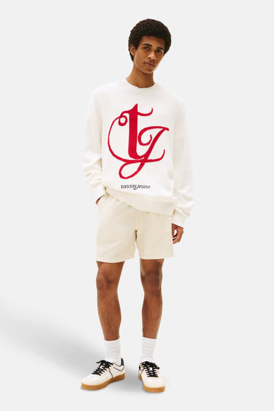 T-shirt blanc avec col rond de TOMMY JEANS, dot un grand grand rouge rouge sur la laant.