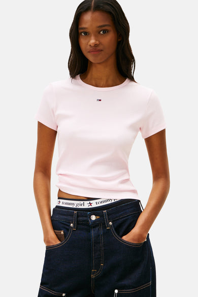 T-shirt rose à manches courtes de TOMMY JEANS, vu de derrière, associé à un pantalon de jeans foncé à jambes larges.