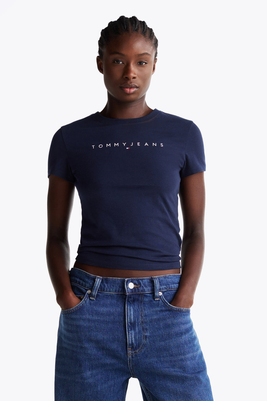 Blauw T-shirt met korte mouwen van TOMMY JEANS, gedragen met een blauwe spijkerbroek met rechte pijpen.