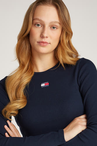 Blauw T-shirt met lange mouwen van TOMMY JEANS, met logo op de borst en gekruiste armen.

