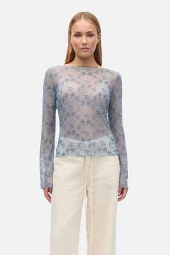 Chemisier bleu à manches longues d'ENVII, avec un motif floral sur tissu transparent.