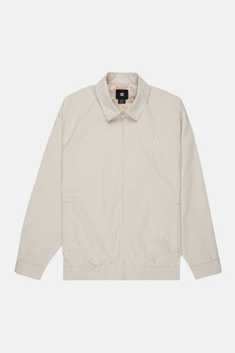 Veste courte beige de DC SHOES, avec fermeture éclair et logo discret sur la poitrine.