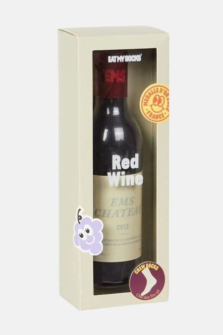 Chaussettes multicolores d'EAT MY SOCKS dans un emballage en forme de bouteille avec un étiquette de raisin et un médaillon.